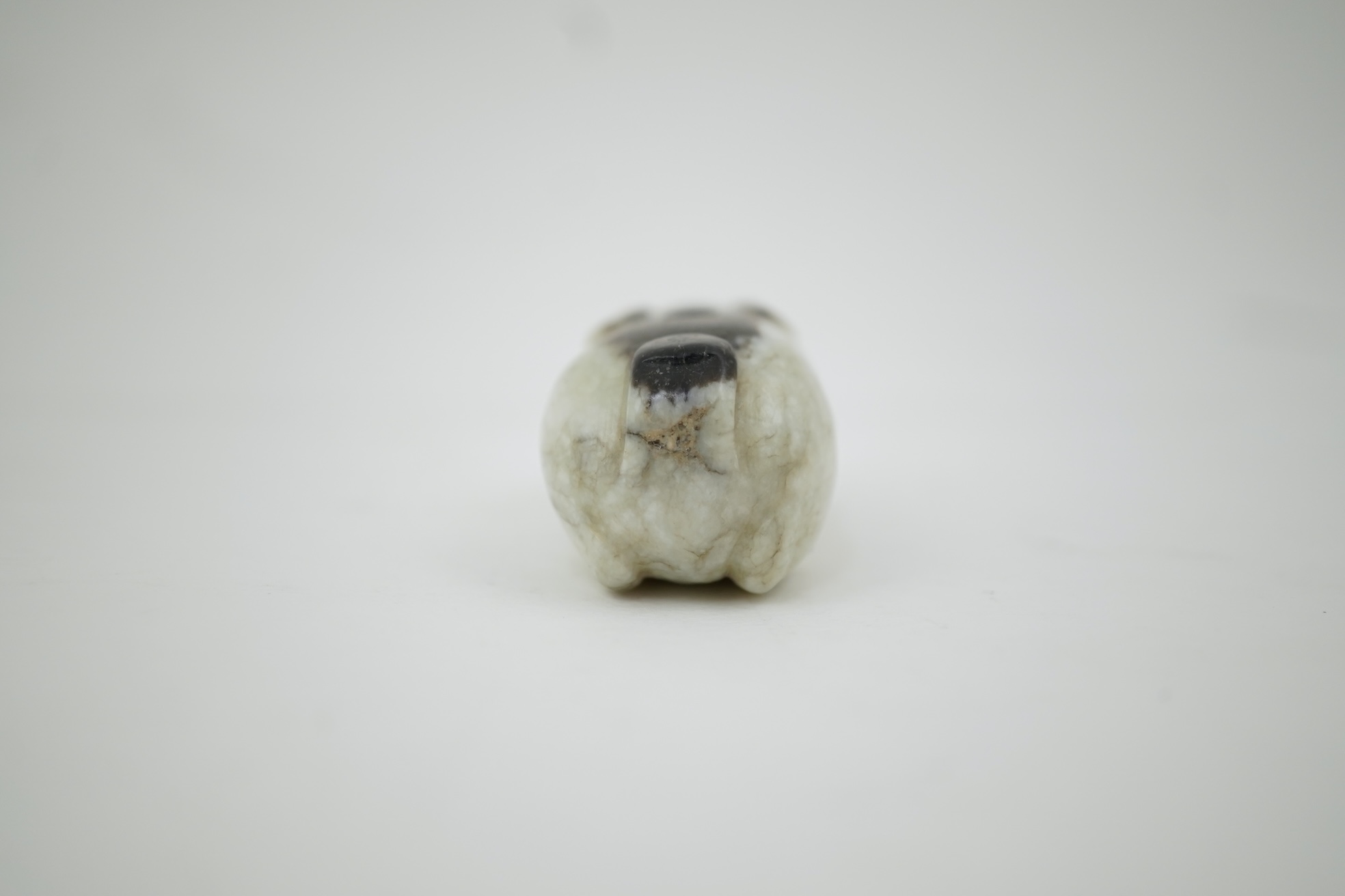 A Chinese white and black jade figure of a recumbent tiger, Song dynasty
